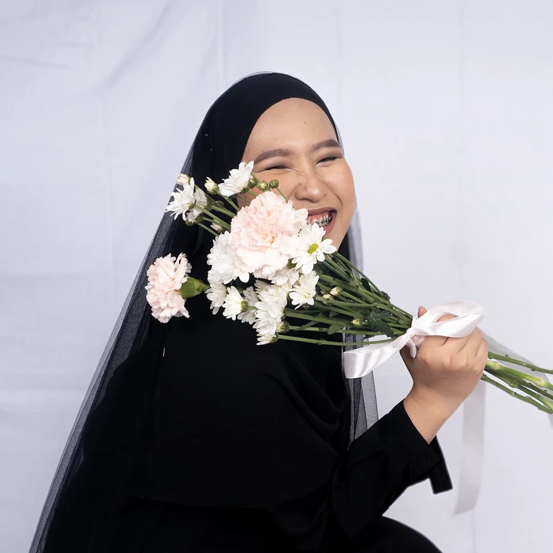 Zahra smiling through the lenses